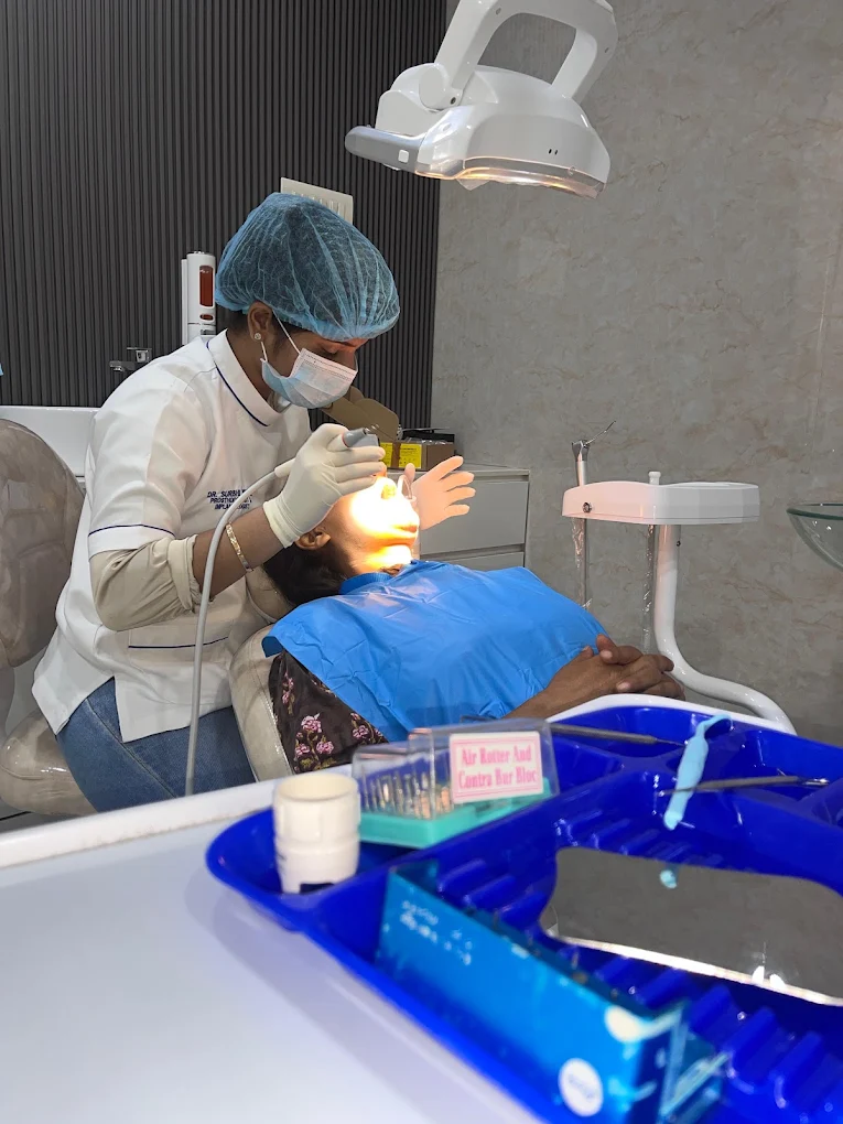 Dentist providing care to a patient at Dr. Komal